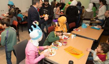 Family sitting at tables eating lunch
